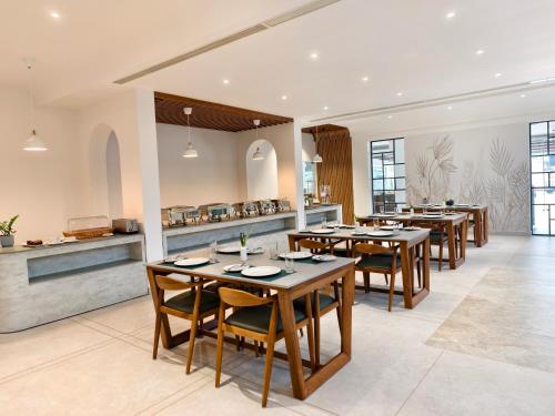 尼杜巴塞莱CASTELO Inn的餐厅设有木桌、椅子和柜台