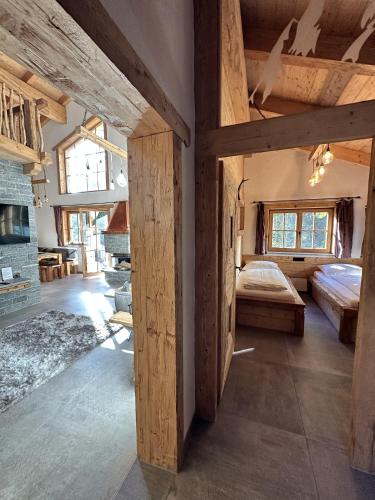 a large room with a bed and a fireplace at Chalet am Bachl 2 in Flattach