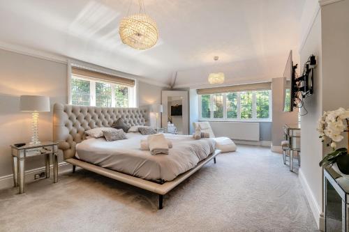 a bedroom with a large bed and a large window at Old Lakenham by Group Retreats in Boughton Monchelsea