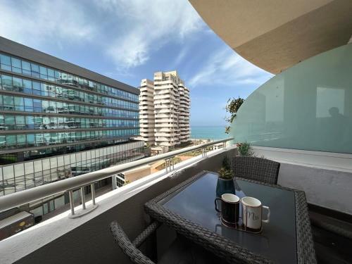 a table on a balcony with a view of the ocean at Sea and Marina View - By AppartAli in Casablanca-Port