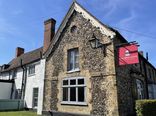 an old brick building with a sign on it at The Red Lion Hotel in Cambridge
