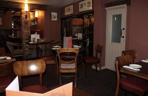 a dining room with tables and chairs in a restaurant at The Red Lion Hotel in Cambridge