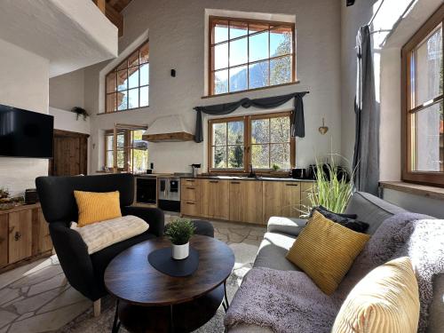 a living room with a couch and a table at Chalet am Bachl 1 in Flattach