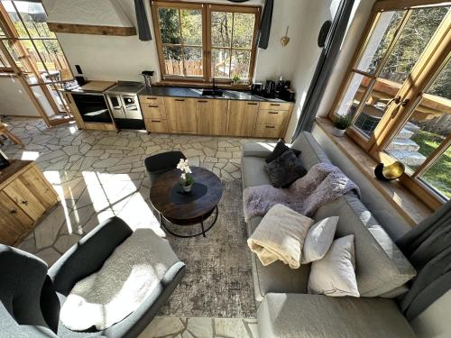 a living room with two couches and a table at Chalet am Bachl 1 in Flattach