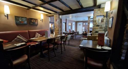 a restaurant with tables and chairs and a bar at The Red Lion Hotel in Cambridge