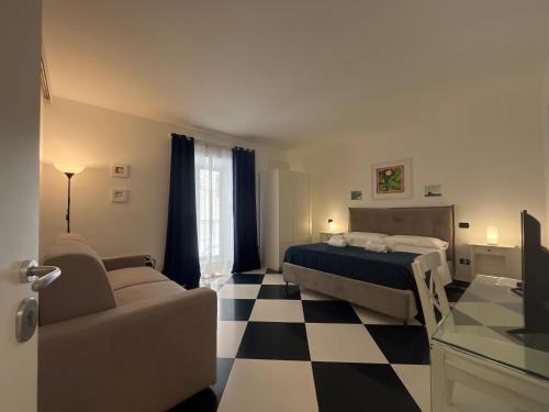 a bedroom with a bed and a checkered floor at Casa Galati in Palermo