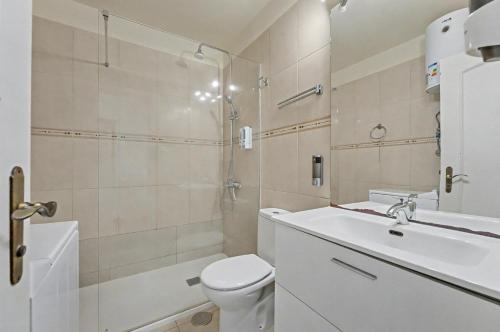 a bathroom with a toilet and a sink and a shower at Penthouse apartment with AC heated pool Golf del Sur in San Miguel de Abona
