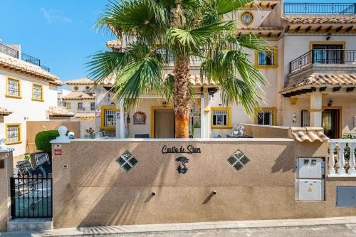 a palm tree in front of a building with a skateboard ramp at Siam's House in Villacosta