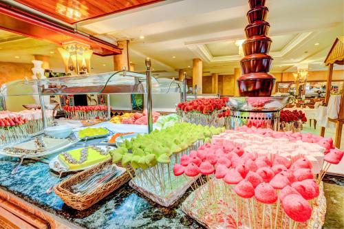 a buffet with pink and green desserts on a table at SBH Costa Calma Beach Resort Hotel in Costa Calma