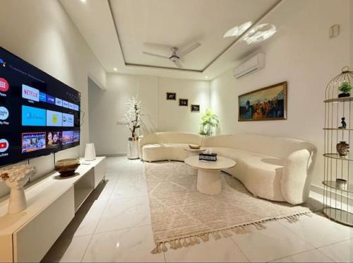 a large living room with a tub and a tv at Zameen Opal luxury Stay LDA Avenue Raiwind Rd in Lahore