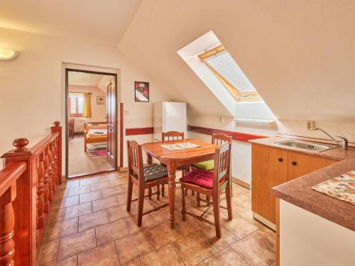 a kitchen with a table and chairs in a room at Holiday Home Lika by Interhome in Úhlejov