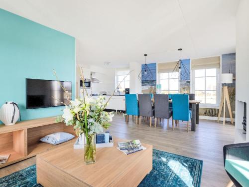 a living room with a vase of flowers on a table at Holiday Home Tapuit 6-2 by Interhome in Noordwijk