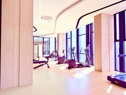 a gym with treadmills and ellipticals in a building at AXON RESIDENCE BUKIT BINTANG KLCC by FIRST CLASS in Kuala Lumpur