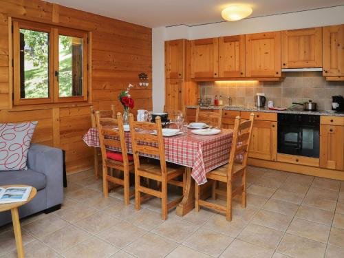 a kitchen and dining room with a table and chairs at Apartment Les Chalets de Marie A 22 by Interhome in Ovronnaz