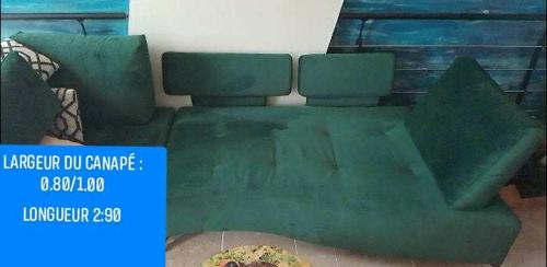 a green couch with a pizza on a table at Cosicocoon in Port-Vendres