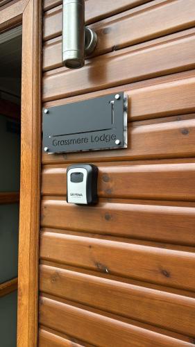 a door with a sign that reads christmaseper lodge at Hot Tub Lake District Lodge - Windermere in Troutbeck Bridge