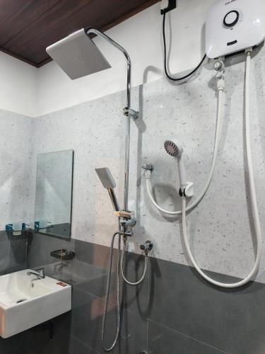 a bathroom with a shower and a sink at Samara Beach Stay in Weligama