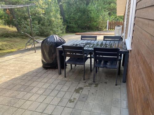 a table and chairs on a patio at Holiday Home Orpah - 2-5km from the sea by Interhome in Kongsmark