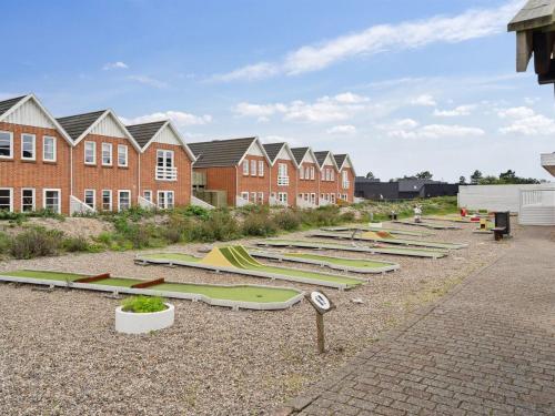 a row of surfboards on the ground in front of houses at Apartment Edly - 2-3km from the sea by Interhome in Sønderby