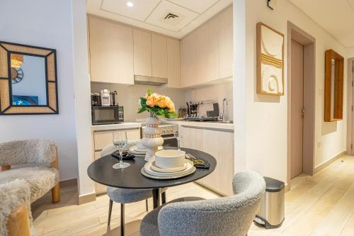 a kitchen and dining room with a table and chairs at Relaxed Luxe Studio - Elegant City Escape in Abu Dhabi