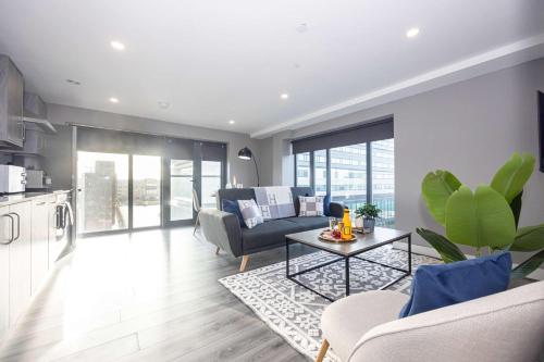 a living room with a couch and a table at Stunning Liverpool Dockside Apt by City SuperHost in Liverpool