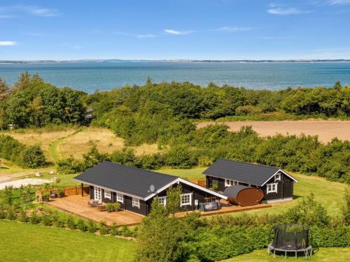 an aerial view of a house with the ocean in the background at Holiday Home Gizella - 500m to the inlet by Interhome in Spottrup