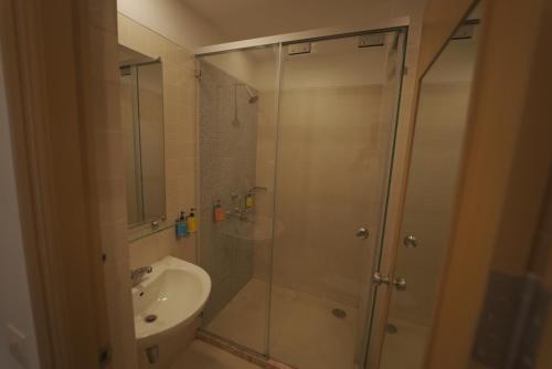 a bathroom with a shower and a toilet and a sink at Mango Grove Hotel in Chandīgarh