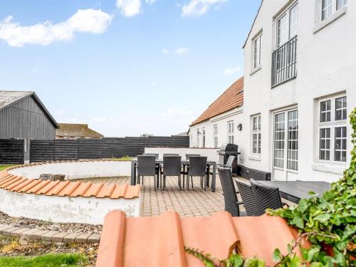 a patio with black chairs and tables in a building at Holiday Home Thorge - 75m to the inlet by Interhome in Struer