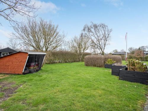 a garden with a small shed on the grass at Holiday Home Kjartan - 32m to the fjord by Interhome in Hemmet