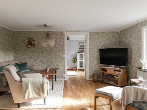 a living room with a couch and a flat screen tv at Holiday Home Skjutsmåla by Interhome in Olofström