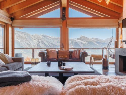 a living room with a view of mountains at Chalet Chalet Gerritsen by Interhome in Nendaz