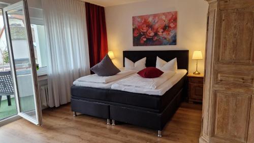a bedroom with a bed with two pillows on it at Apart Hotel Freiburg in Freiburg im Breisgau