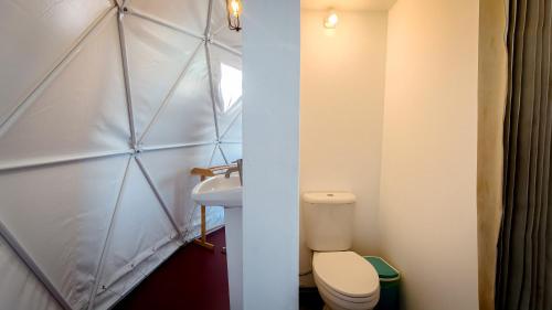 a small bathroom with a toilet and a sink at Infinity Beach Club Resort & Hostel Koh Phangan in Baan Tai