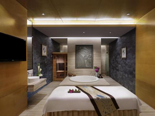 a large bathroom with a large tub and a sink at Pullman Wuxi New Lake in Wuxi