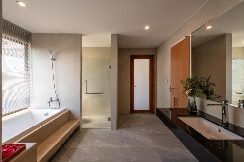 ein Badezimmer mit Badewanne, Dusche und Waschbecken in der Unterkunft Lanna Fusion in Hang Dong