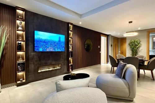 a living room with a tv on a wall at State of Peace in Marina - By AppartAli in Casablanca-Port