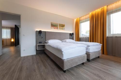a bedroom with two beds in a room at Lorenzhaus Exclusive Residence in Sankt Lorenz