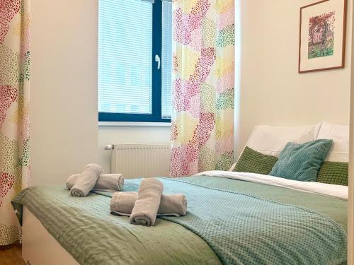 a bedroom with a bed with towels on it at Urban stay Bratislava City in Bratislava