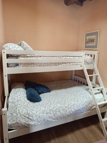 a white bunk bed with a blue stuffed animal on it at Casa rural TIO PEDRITO in Robledillo