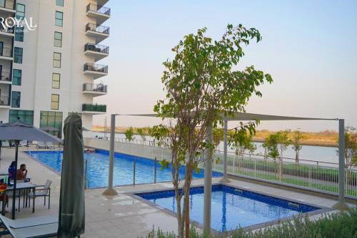 a swimming pool on the side of a building at Relaxed Luxe Studio - Elegant City Escape in Abu Dhabi