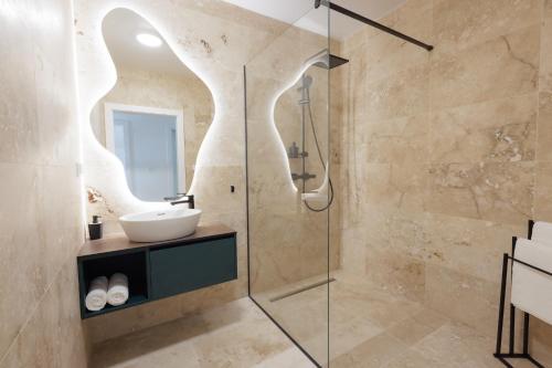 a bathroom with a sink and a shower at Quantara Resort Domaša - Free Wellness in Holčíkovce