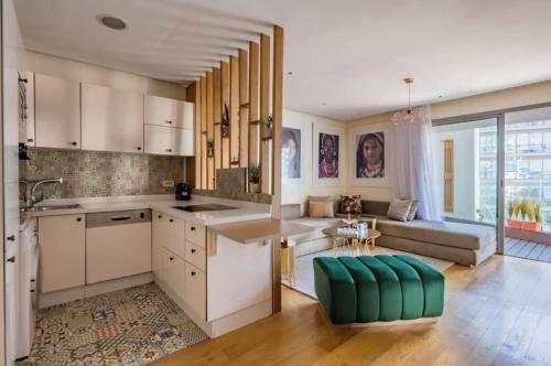 a kitchen with white cabinets and a living room at Marina Chalet Ocean View - By AppartAli in Casablanca-Port