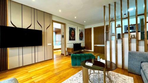 a living room with a flat screen tv on a wall at Marina Chalet Ocean View - By AppartAli in Casablanca-Port