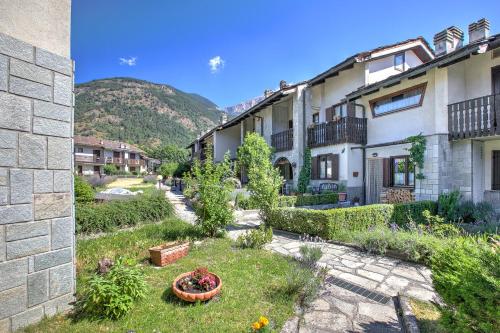 a courtyard of a building with a mountain in the background at Maison Rosamunda - Happy Rentals in Oulx