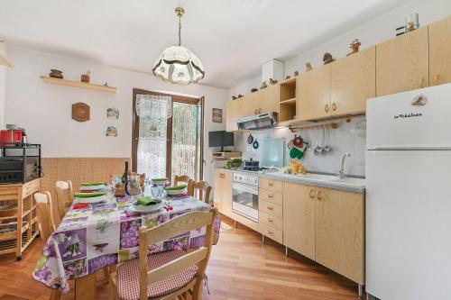a kitchen with a table with a table cloth on it at Maison Rosamunda - Happy Rentals in Oulx