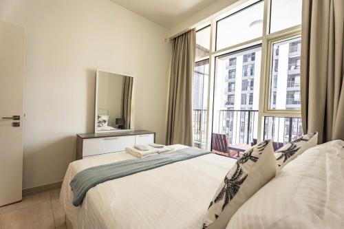 a bedroom with a bed and a large window at Reem Island Modern 1BR Pool, Gym, City View in Abu Dhabi