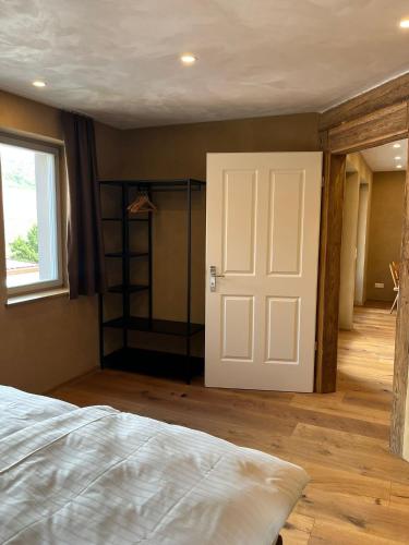 a bedroom with a white door and a closet at Bio Bausewein - Ferienwohnung 2 in Iphofen