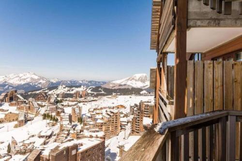 a view of a city in the snow from a balcony at Résidence Antarès - Avoriaz in Morzine