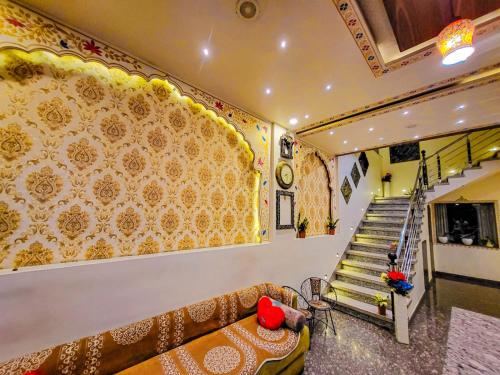 a living room with a couch and a staircase at Hotel Paradise inn in Udaipur