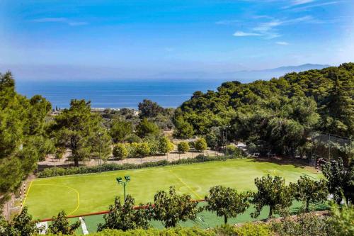 an aerial view of a golf course with the ocean in the background at Villa Laurette Kratigos - Private Escape with Views in Pligónion